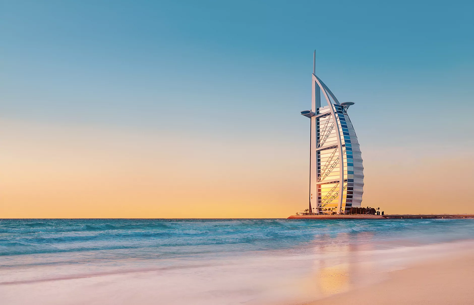 Burj Al Arab at sunset over the sea in Dubai.